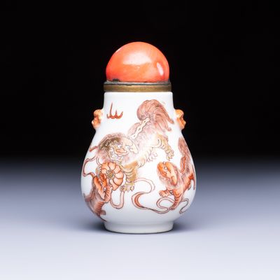 A Chinese gilt iron-red-decorated 'Buddhist Lions' snuff bottle with a red coral stopper, Buddhist Lion mark, Republic