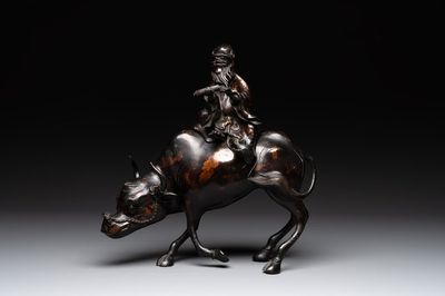 A Chinese gold-splashed bronze incense burner in the shape of an immortal riding a buffalo, 19th C.