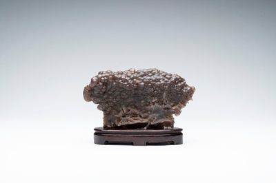 A Chinese grape agate scholar's rock on wooden stand, 20th C.