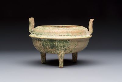 A Chinese green-glazed pottery ritual tripod food vessel with handles, 'Ding 鼎', Han