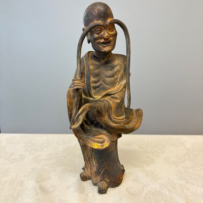 A Chinese inscribed lacquered gilt-bronze figure of a luohan — photo 1