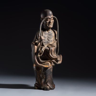 A Chinese inscribed lacquered gilt-bronze figure of a luohan, signed Li Yuan Dao Ren 歷元道人, Ming or earlier