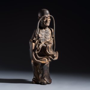 A Chinese inscribed lacquered gilt-bronze figure of a luohan — photo 1