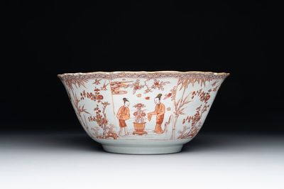 A Chinese iron-red and gilt-decorated 'ladies in a garden' bowl, Kangxi