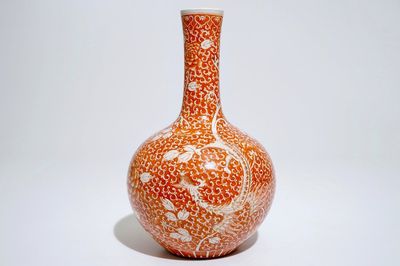 A Chinese iron red and gilt phoenix bottle vase, 19th C.