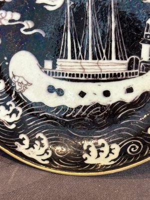 A Chinese iron-red 'bat' saucer and a black-glazed 'ship' saucer with calligraphy, Guangxu mark, 19th C. — photo 14