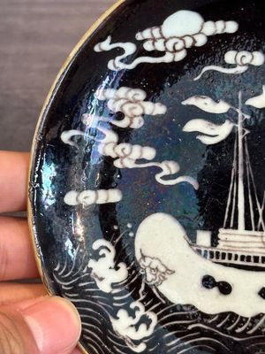 A Chinese iron-red 'bat' saucer and a black-glazed 'ship' saucer with calligraphy, Guangxu mark, 19th C. — photo 15