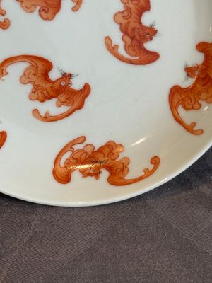 A Chinese iron-red 'bat' saucer and a black-glazed 'ship' saucer with calligraphy, Guangxu mark, 19th C. — photo 5