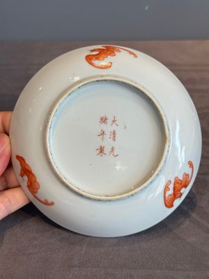 A Chinese iron-red 'bat' saucer and a black-glazed 'ship' saucer with calligraphy, Guangxu mark, 19th C. — photo 6