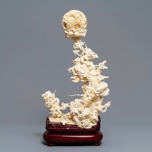 A Chinese ivory 'dragons with puzzle ball' group, 1st quarter 20th C. — photo 1