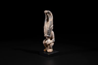 A Chinese jade carving of a crouched figure, possibly Hongshan culture