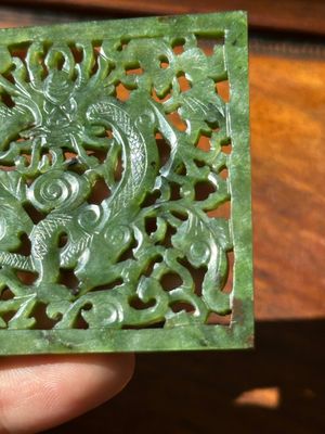 A Chinese jade 'dragon' plaque, a 'double-happiness' plaque and a jade inset silver brooch, 19th C. — photo 16