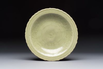 A Chinese Longquan celadon inscribed dish with incised floral design, Ming