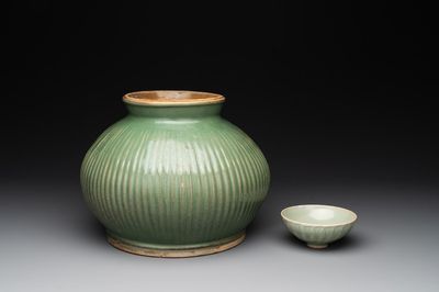 A Chinese Longquan celadon 'lotus' bowl and a large green-glazed jar, Ming and later