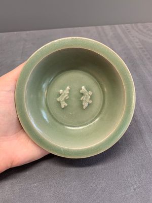 A Chinese Longquan celadon 'twin fish' dish and two 'twin fish' saucers, Yuan/Ming — photo 2