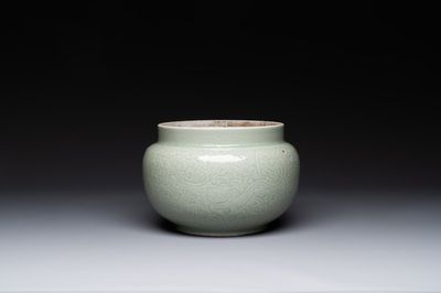 A Chinese monochrome celadon-glazed jar with anhua chilong and floral design, Kangxi