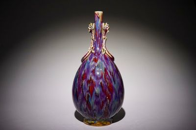 A Chinese monochrome flambe-glazed bottle vase with dragon handles, 19th C.
