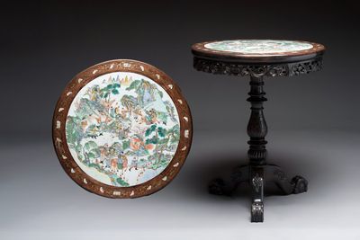 A Chinese mother-of-pearl-inlaid hongmu table with a circular Canton famille verte 'warriors on horseback' plaque, 19th C.