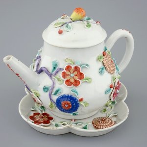 A Chinese moulded and applied famille rose teapot and cover on stand, Yongzheng, 1723-1735 — photo 1