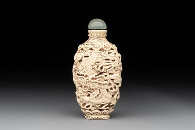 A Chinese moulded cream-glazed 'dragon and phoenix' snuff bottle, Jiaqing mark, 19th C.