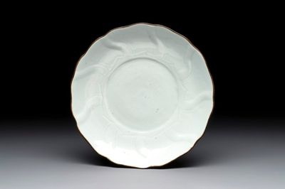 A Chinese moulded white-glazed plate with anhua floral design and a copper-mounted rim, Xuande mark, late Ming