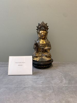 A Chinese parcel-gilt bronze Guanyin and wooden stand, Ming — photo 1