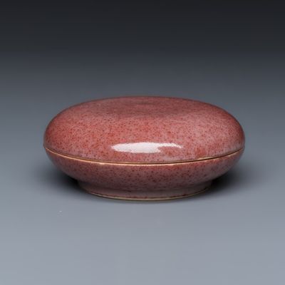 A Chinese peachbloom-glazed seal paste box, Kangxi mark, 19th C.