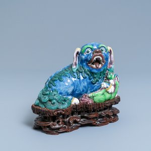 A Chinese porcelain 'Buddhist lion and cub' group on carved wooden stand, 19th C. — photo 1