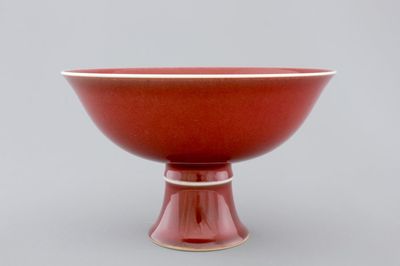 A Chinese porcelain copper-red glazed bowl on foot, 19/20th C.