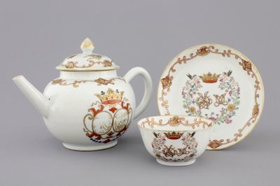 A Chinese porcelain famille rose and gilt armorial monogrammed teapot with a cup and saucer, 18th C.