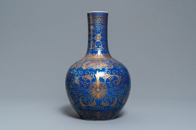A Chinese powder blue and gilt 'lotus scroll' bottle vase, Kangxi mark, 19/20th C.