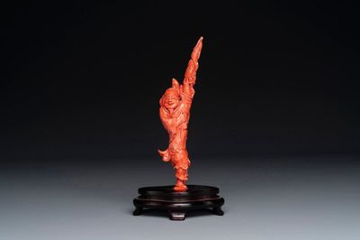 A Chinese red coral figure of a fisherman on wooden stand, 19/20th C.