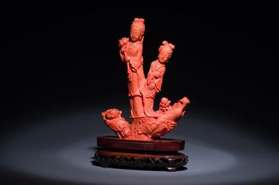 A Chinese red coral group of two standing ladies with lotus flowers, 19/20th C.
