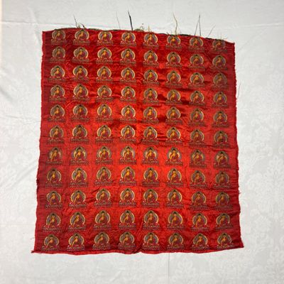 A Chinese red-ground brocade panel with seated Buddhas — photo 1