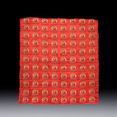 A Chinese red-ground brocade panel with seated Buddhas, 20th C.
