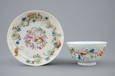 A Chinese relief-decorated famille rose cup and saucer with squirrels, Yongzheng, 1723-1735