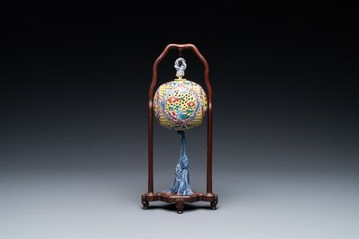 A Chinese reticulated famille rose fragrance ball, 19th C.