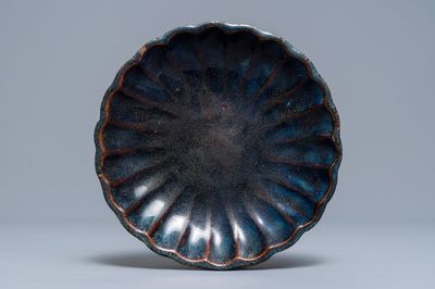 A Chinese Shiwan flambé-glazed 'chrysanthemum' dish, impressed mark, 18/19th C.