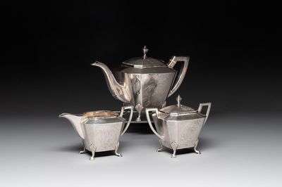 A Chinese silver covered teapot, sugar jar and milk jug with bamboo design, Tackhing 90% silver mark, 20th C.