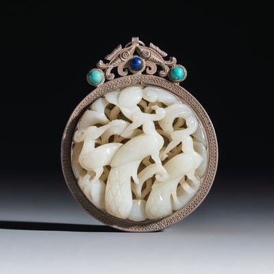 A Chinese silver-mounted openwork jade plaque with birds, Qing