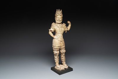 A Chinese stoneware cream-glazed sculpture of a warrior, possibly Tang