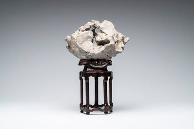 A Chinese Taihu stone scholar's rock on wooden stand, 20th C.