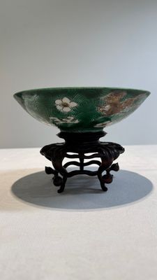 A Chinese verte biscuit 'animals among waves' bowl and a wooden stand, Jiajing mark, Kangxi — photo 1