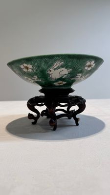 A Chinese verte biscuit 'animals among waves' bowl and a wooden stand, Jiajing mark, Kangxi — photo 2