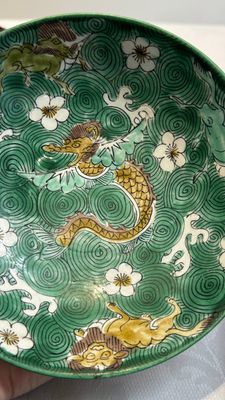 A Chinese verte biscuit 'animals among waves' bowl and a wooden stand, Jiajing mark, Kangxi — photo 6