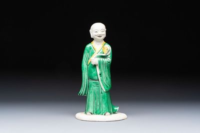 A Chinese verte biscuit Luohan holding a ruyi, Kangxi