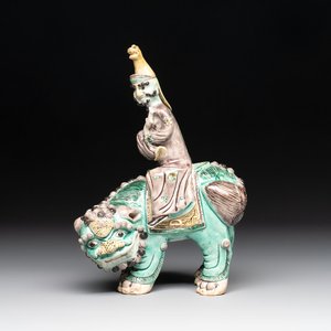 A Chinese verte biscuit 'Sogdian riding a Buddhist lion' group, 19th C. — photo 1