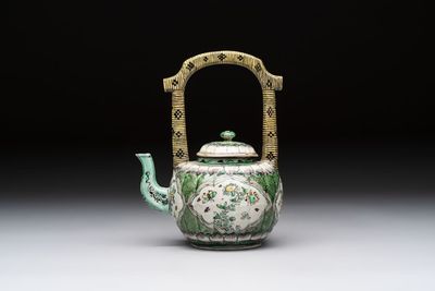 A Chinese verte biscuit teapot and cover with floral design, Kangxi