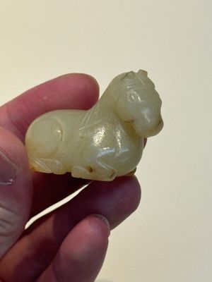 A Chinese white and russet jade pendant in the form of a horse, Song/Ming — photo 11