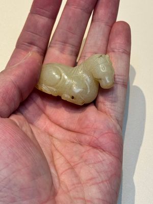 A Chinese white and russet jade pendant in the form of a horse, Song/Ming — photo 2